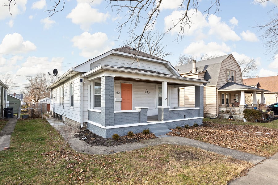 A charming bungalow with a cozy front porch, fresh exterior paint, and a welcoming entrance.