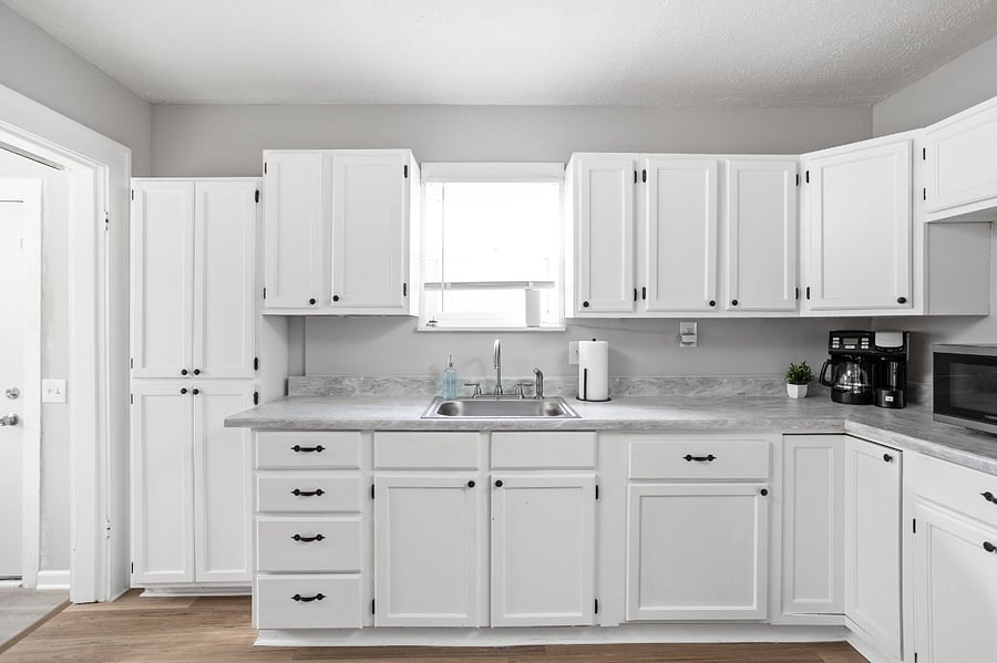 Bright and spacious kitchen with classic white cabinetry and modern appliances.