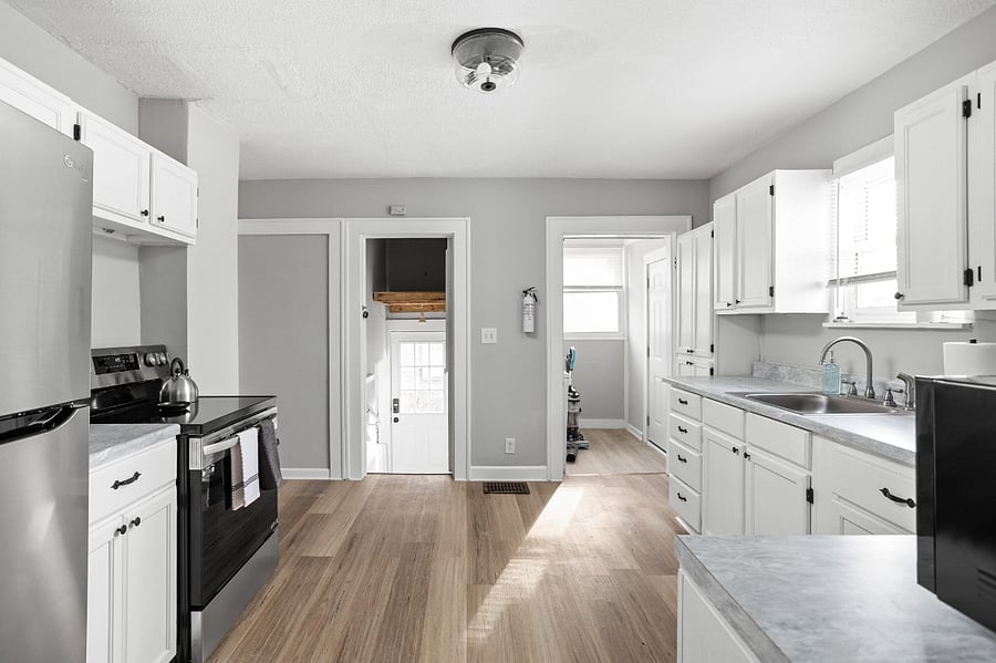 Bright and airy kitchen with sleek white cabinetry and modern appliances.
