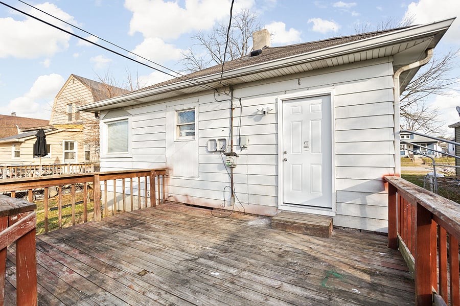 Spacious wooden deck at the back of a home, perfect for outdoor relaxation.