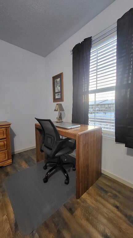 Workspace with desk, chair and lamp located in master bedroom.