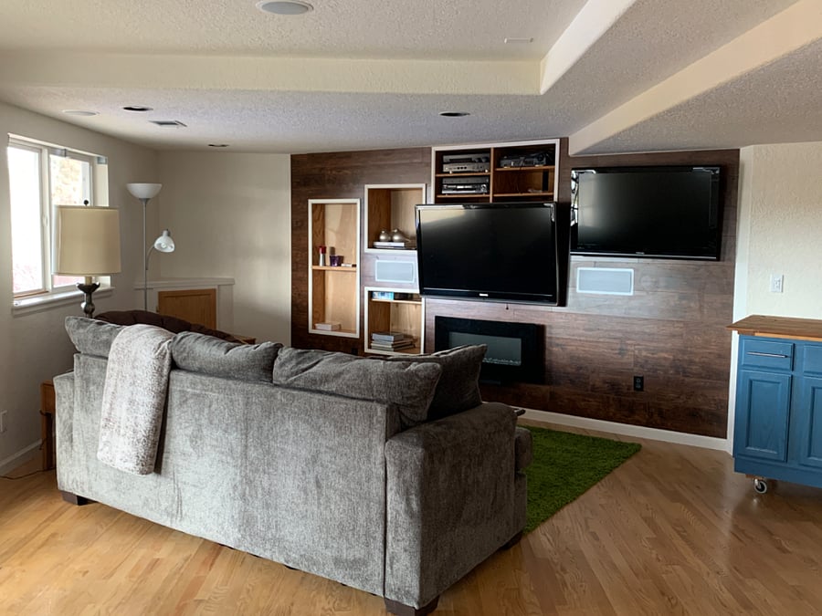 Living space with electric fireplace, two TVs.