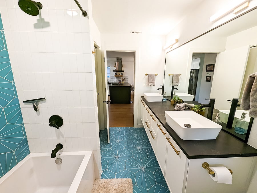 Bright and spacious bathroom with 2 vanities, plenty of countertop space, and spacious bath tub!
