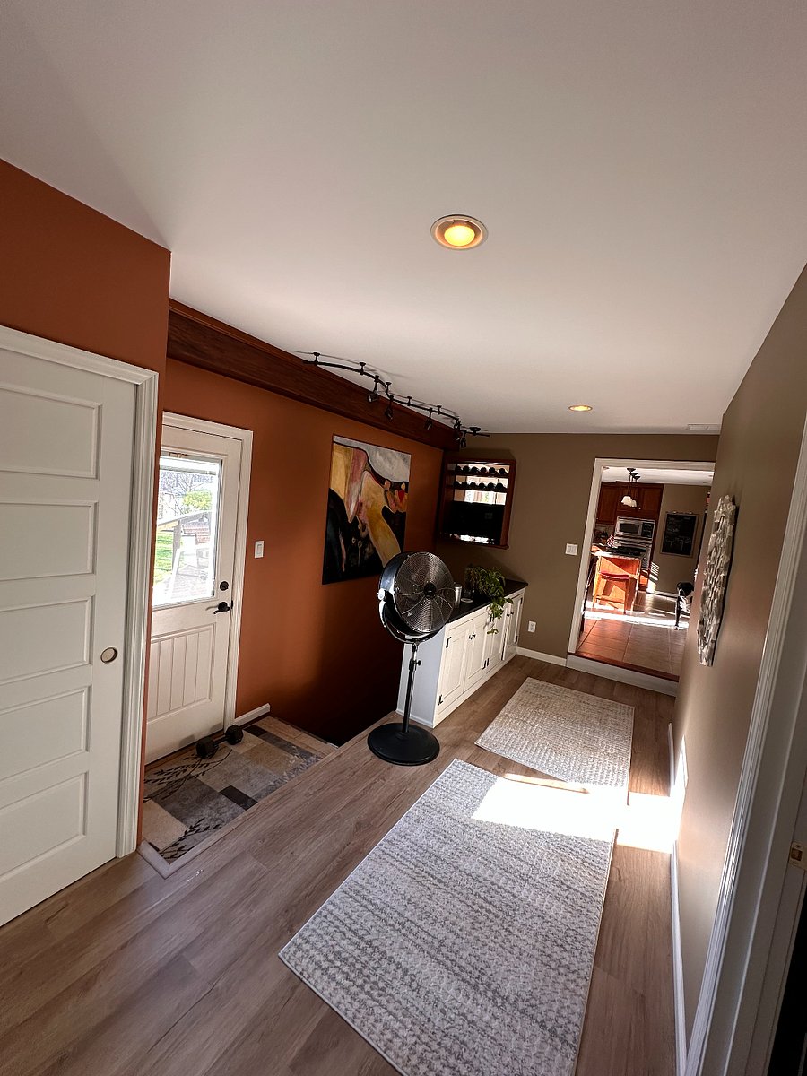 Back hall from entrance to bed room suite looking towards kitchen and rear yard thru secondary rear door that goes to deck