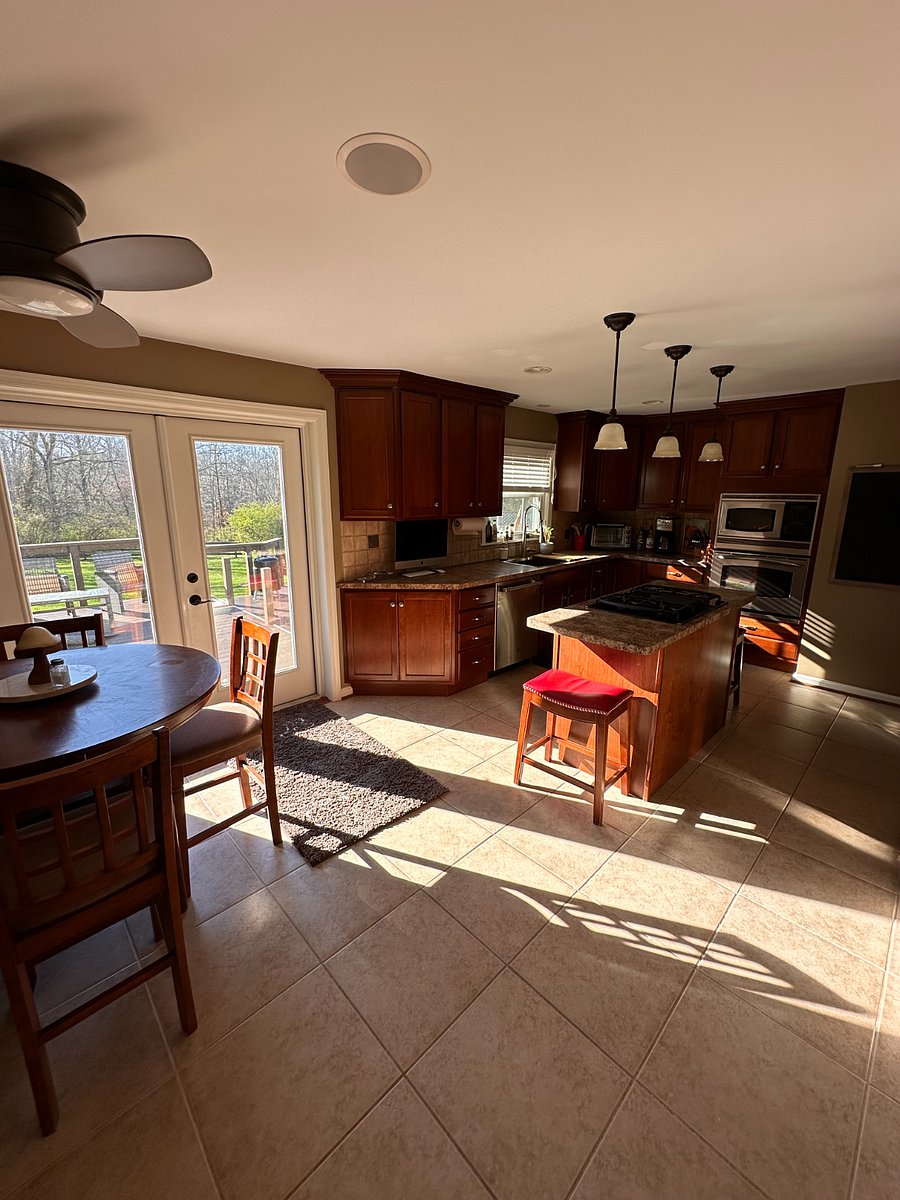 Kitchen, looking towards rear yard through double French doors onto deck