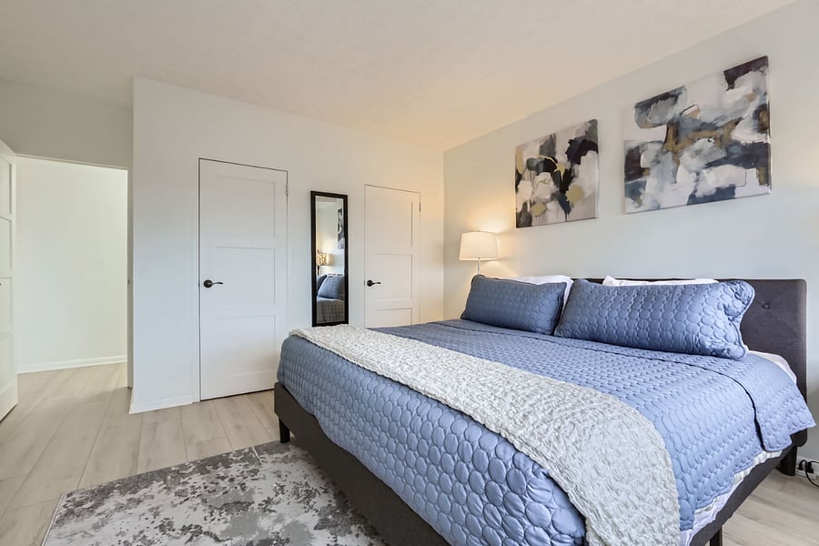 Two walk-in closets with lots of hangers and king size bed with orthopedic pillow top