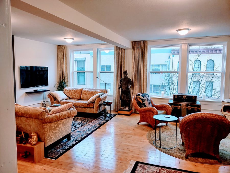 Sofa's and 50" TV on left, seating area and desk on right.