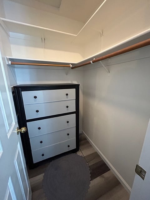 Walk in closet with 5 deep drawers and a lot of shelf space.