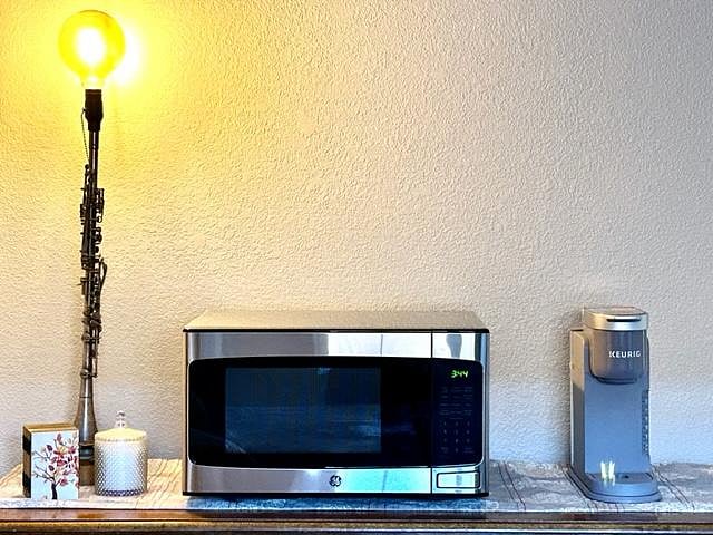 Microwave and coffee brewer in guest room.