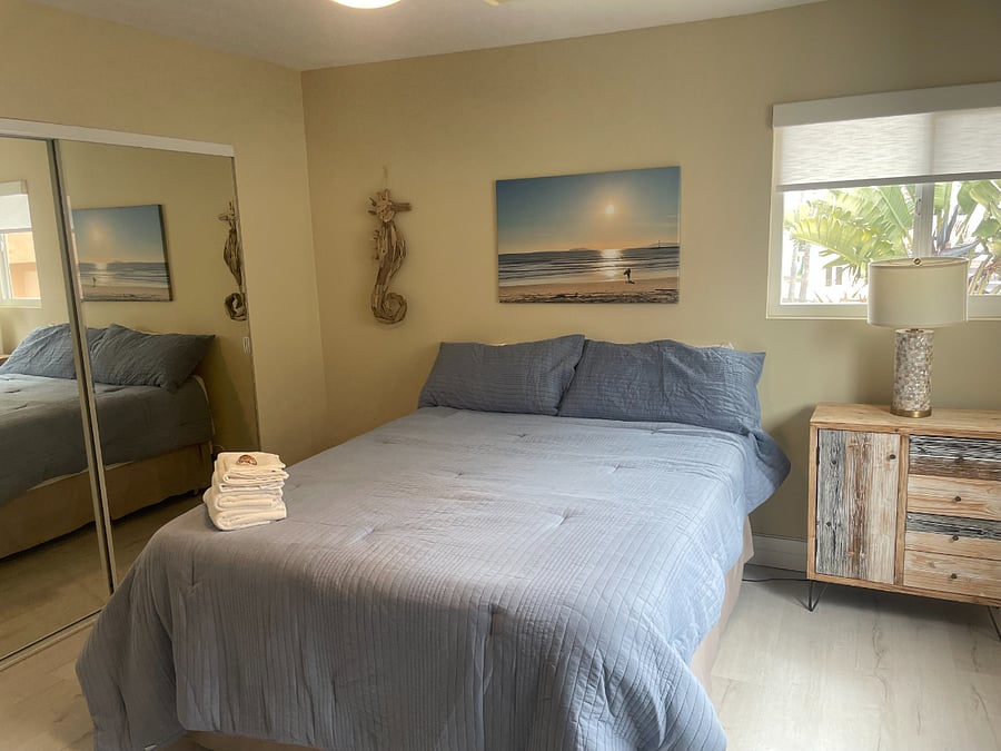 Large 2nd bedroom on main level - Queen bed, 3" plush mattress topper, crips linens, dresser, full-size closed with mirrored wardrobe, ceiling fan, 2 windows and large comfy leather chair with ottoman.