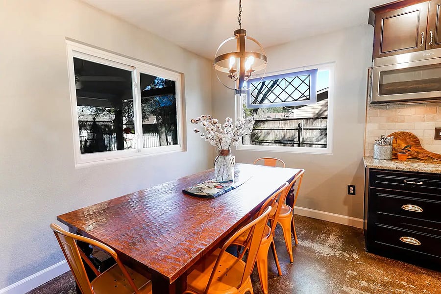 Open kitchen with large family style dining table.