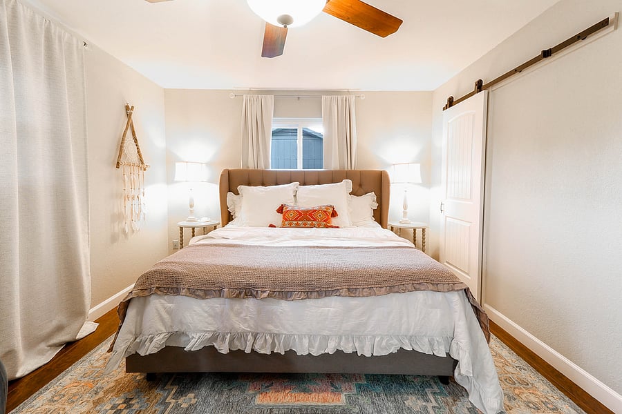 Guest bedroom #3 is a large room with king bed with luxury linens, and a crib, and a changing station.