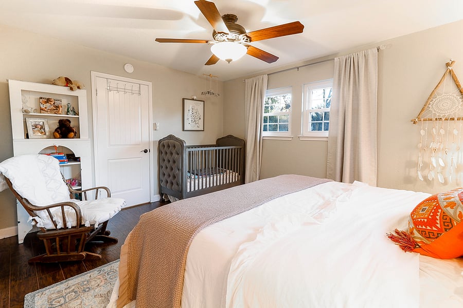 Guest bedroom #3 large king room, luxury bed and linens, crib, rocking chair, kids' books, walk-in closet and changing station.