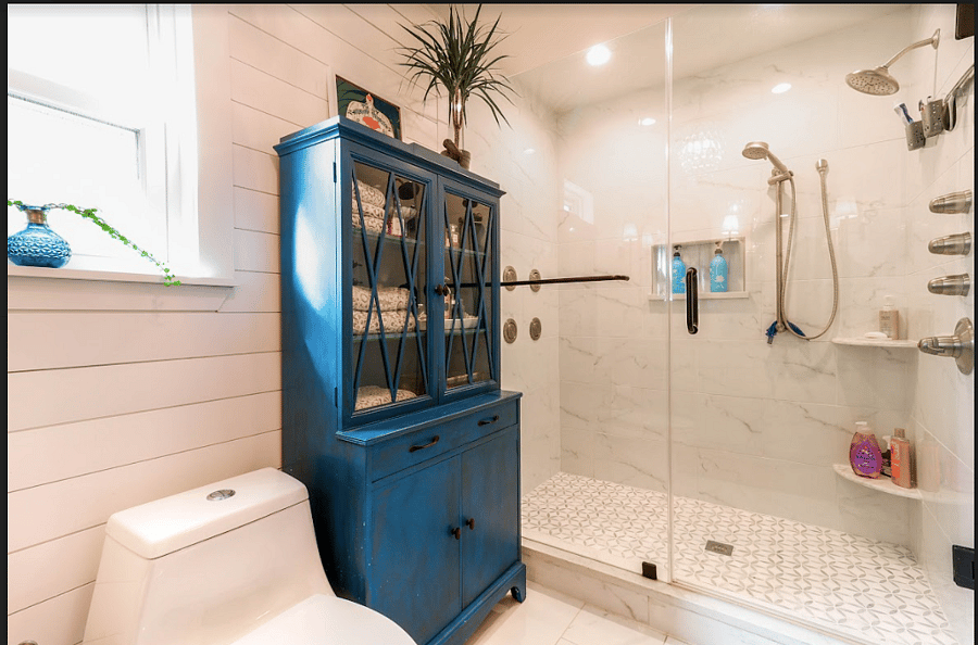 Owner's suite with rain shower head, walk-in shower, and double vanity.