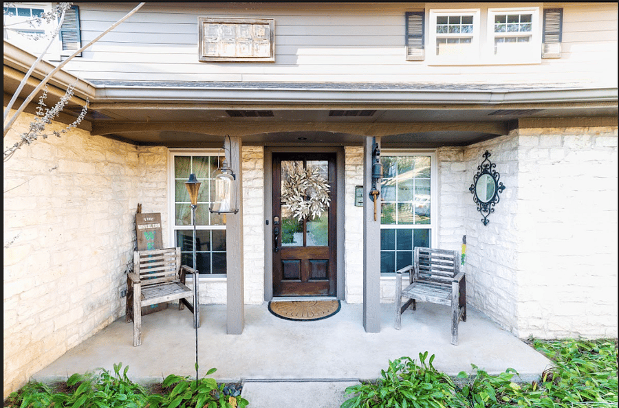 Quaint front porch with seating.
