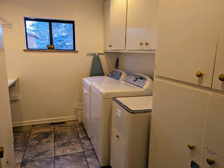 Laundry room with washer, dryer, sink, and folding area