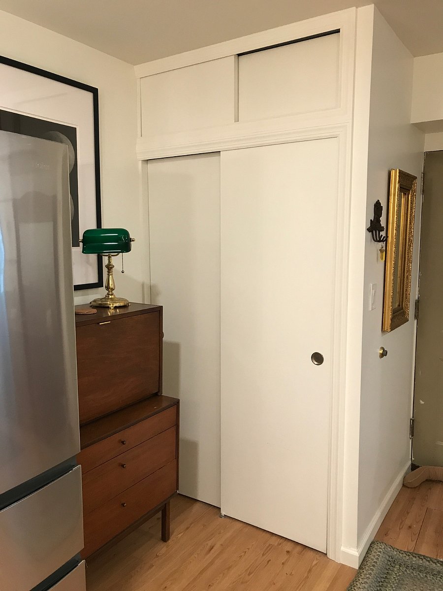 Ample closet space with shoe rack, ironing board and iron