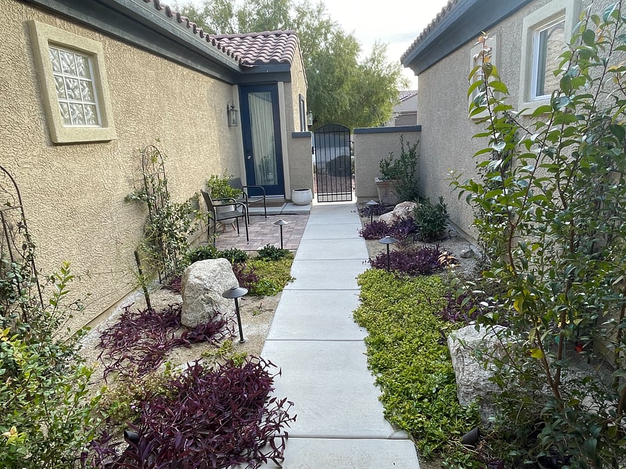 Private entrance in lush courtyard with outdoor seating