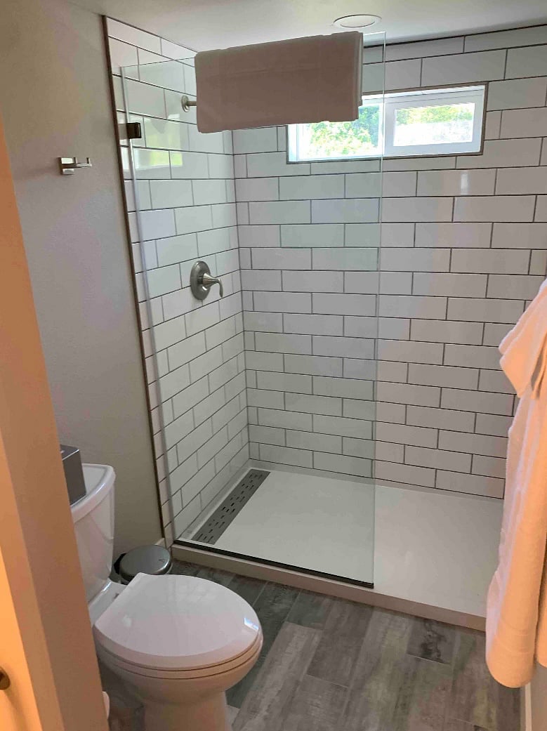 A sliding pocket barndoor can separate the toilet/ shower from the double vanity and mirrors.