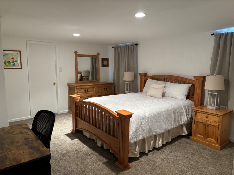 Bedroom 2. Queen size bed with complete set of bedding. Dresser and nightstands with lamps and a very large walk-in closet.