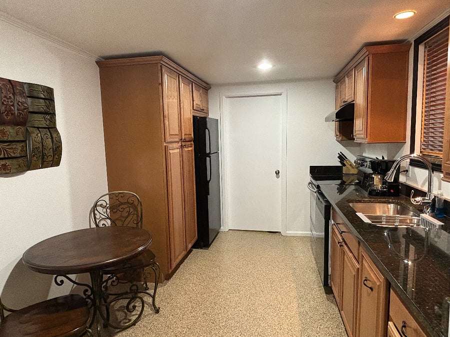 Glass-top range, dishwasher and full size refrigerator with icemaker.