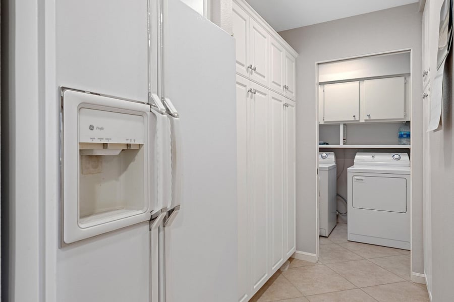 Hall off kitchen leading to laundry room area.