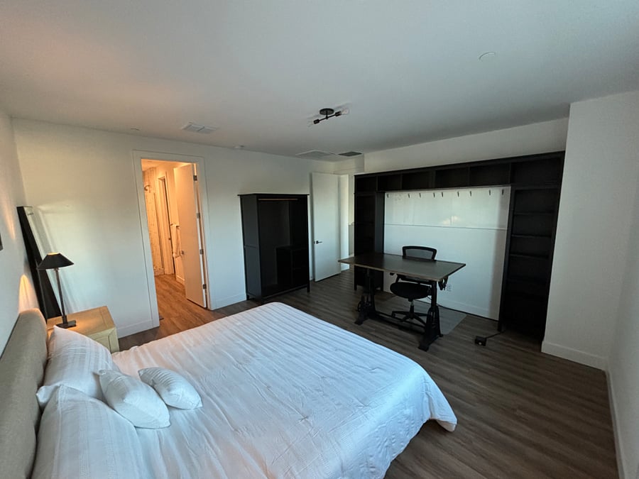 Comfortable WFH space with large desk, bookshelf, and whiteboard 