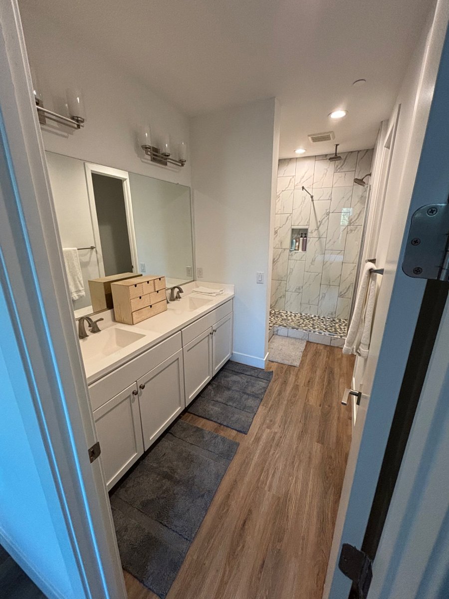 Master bath with double vanity, rain head and standard shower, private toilet room. 