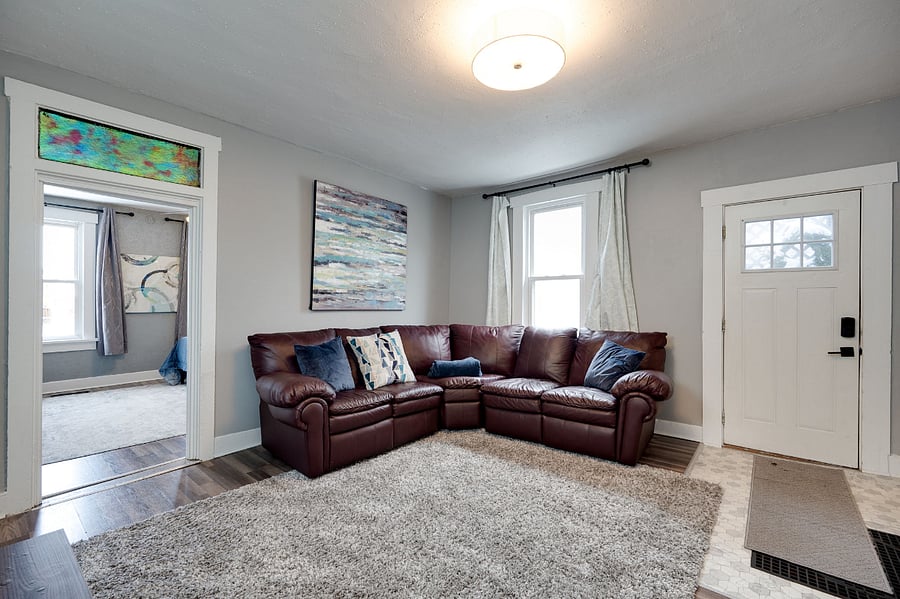 Comfortable sofa with cushions and a blanket for your comfort.