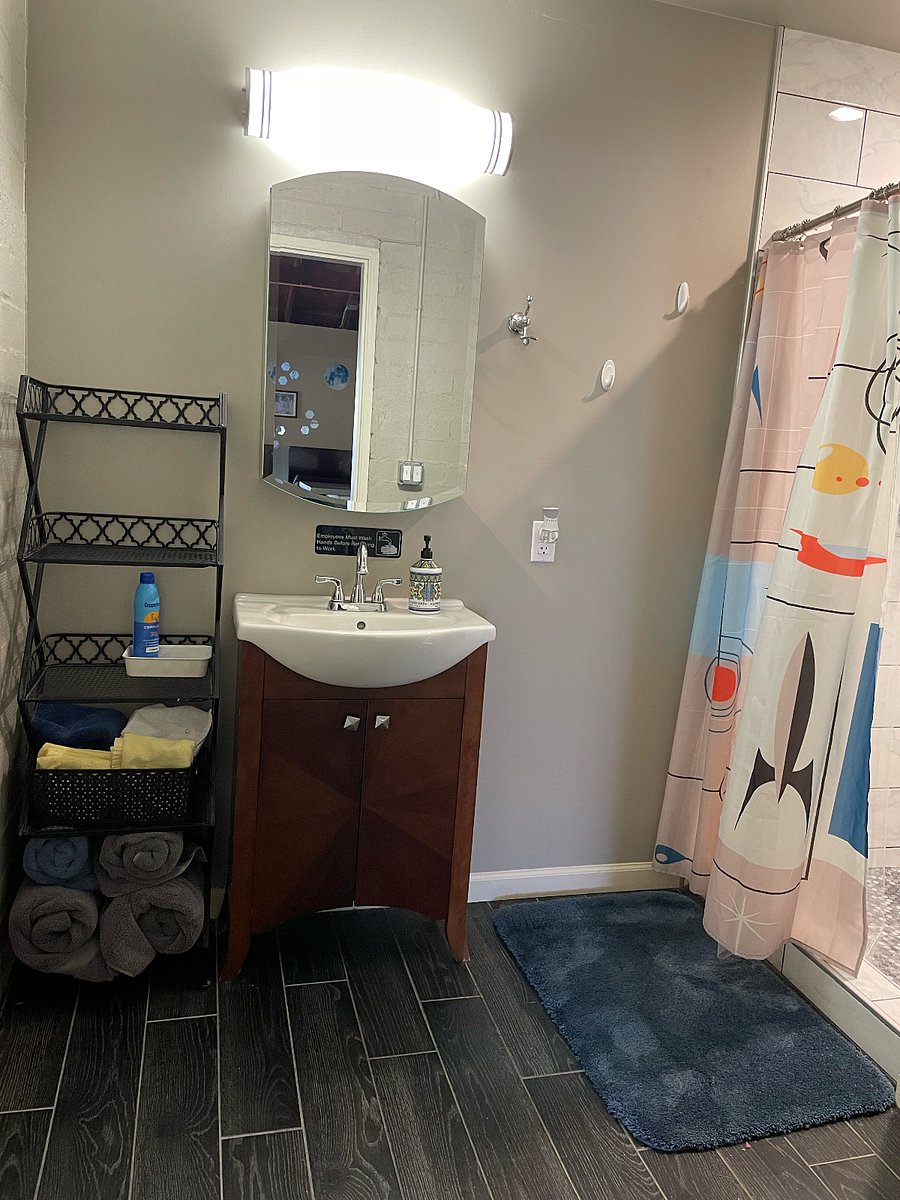Bathroom with storage shelf and medicine cabinet