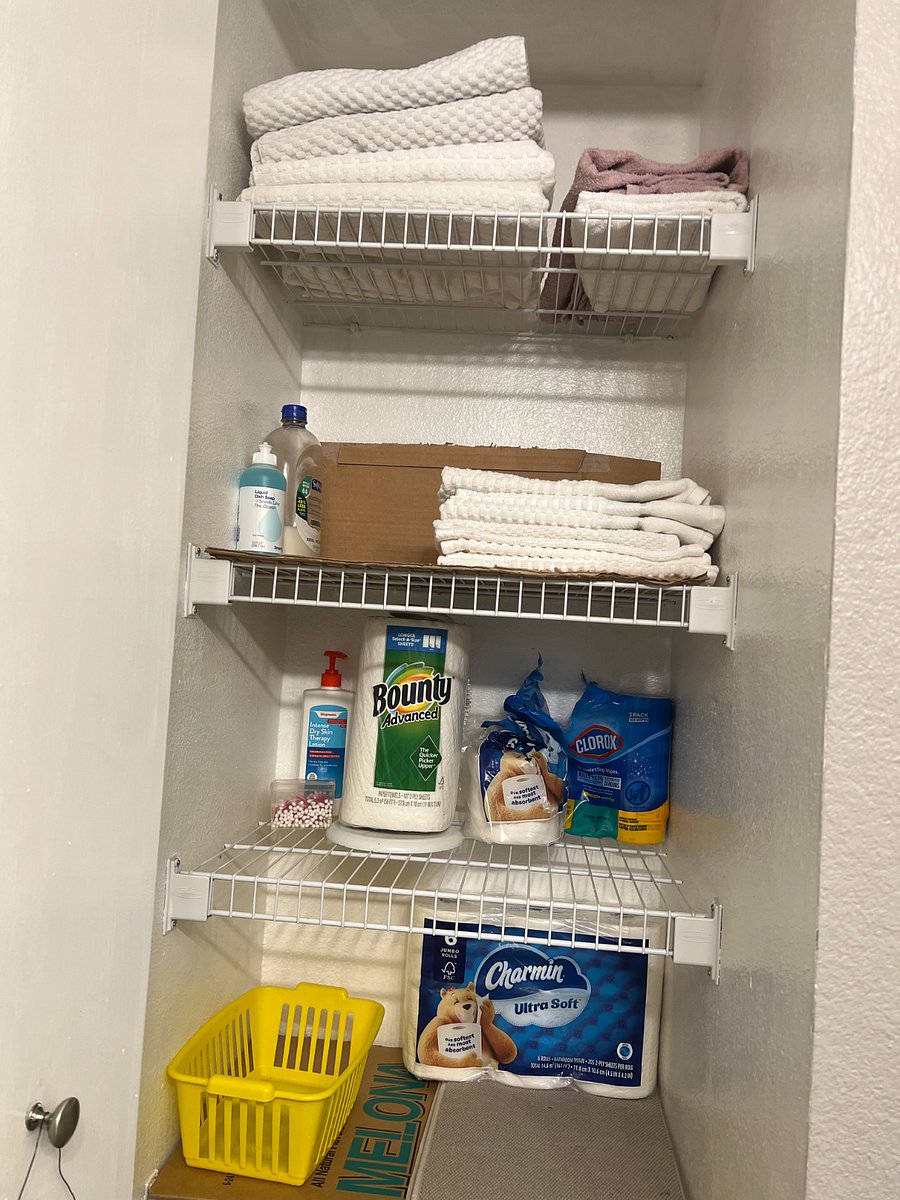 Bathroom cabinet with shelves across the sink.