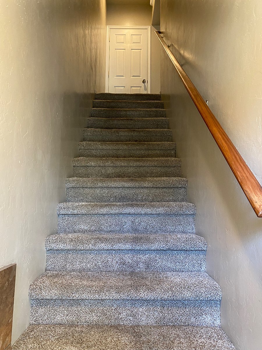 Stairs leading to the bedrooms and full bathroom.