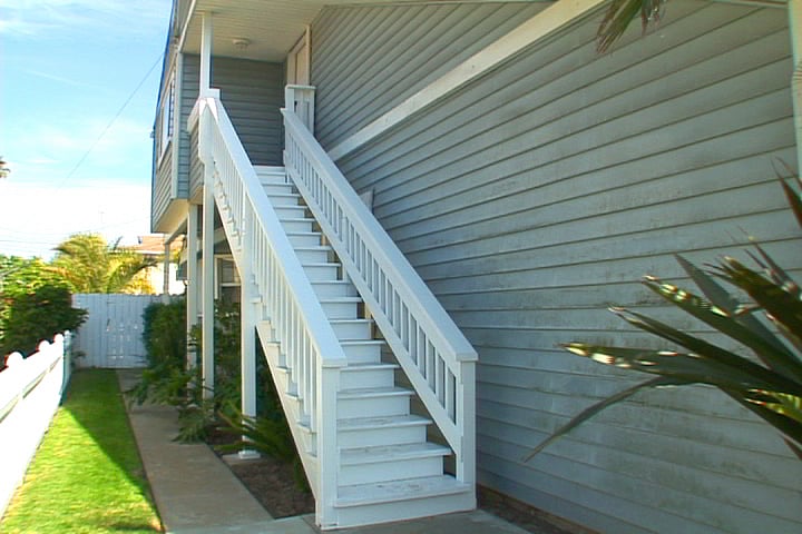 Stairs taking you to your 2nd floor unit.  Left side of the cottage.