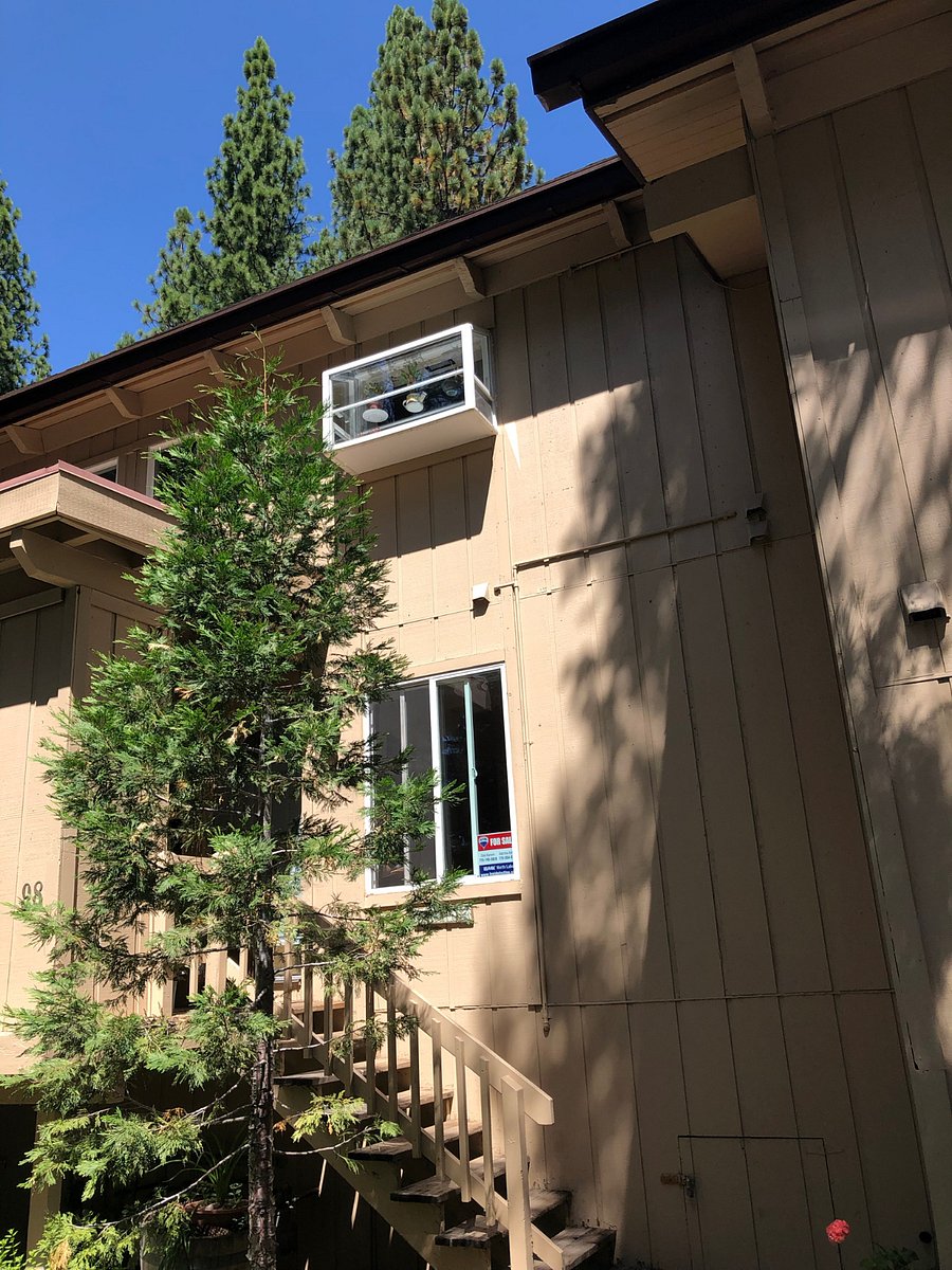 Front showing master bedroom window with kitchen window above