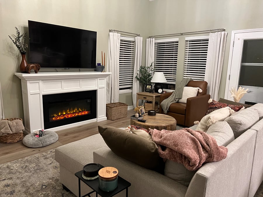 Family room with electric fireplace and 65" Roku tv. Vaulted ceilings.