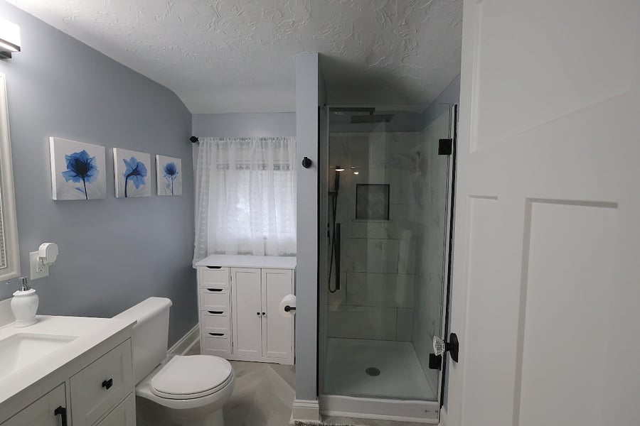 Newly remodeled bathroom with granite tiled shower and rainshower shower head