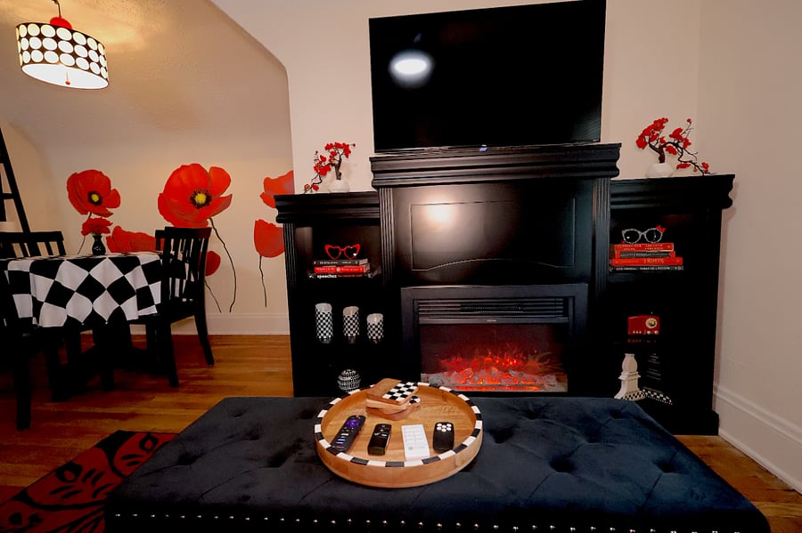 Cozy living room with bookcase/faux fireplace and 42" TV. 