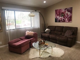 Living room with cathedral ceilings and view of main pool & mountains
