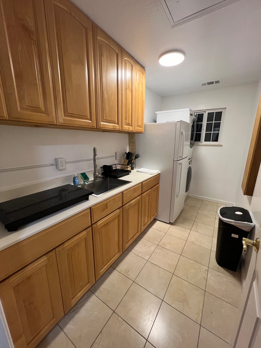 Kitchenette with all the amenities of a full kitchen. Cooktop, utensils, cookware, refrigerator.