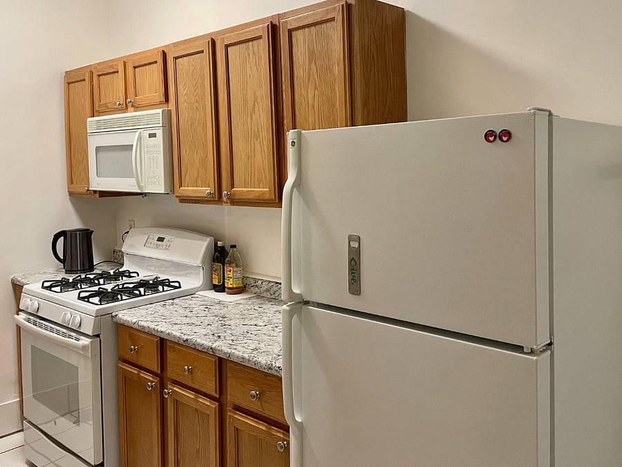 Stove, microwave, cabinets, refrigerator and counter top