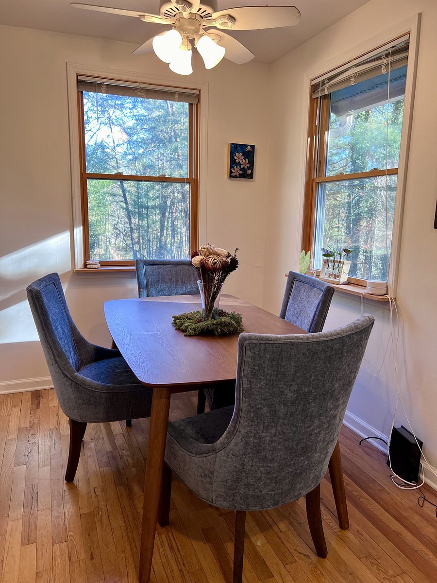 Dining area surrounded by windows and trees!
