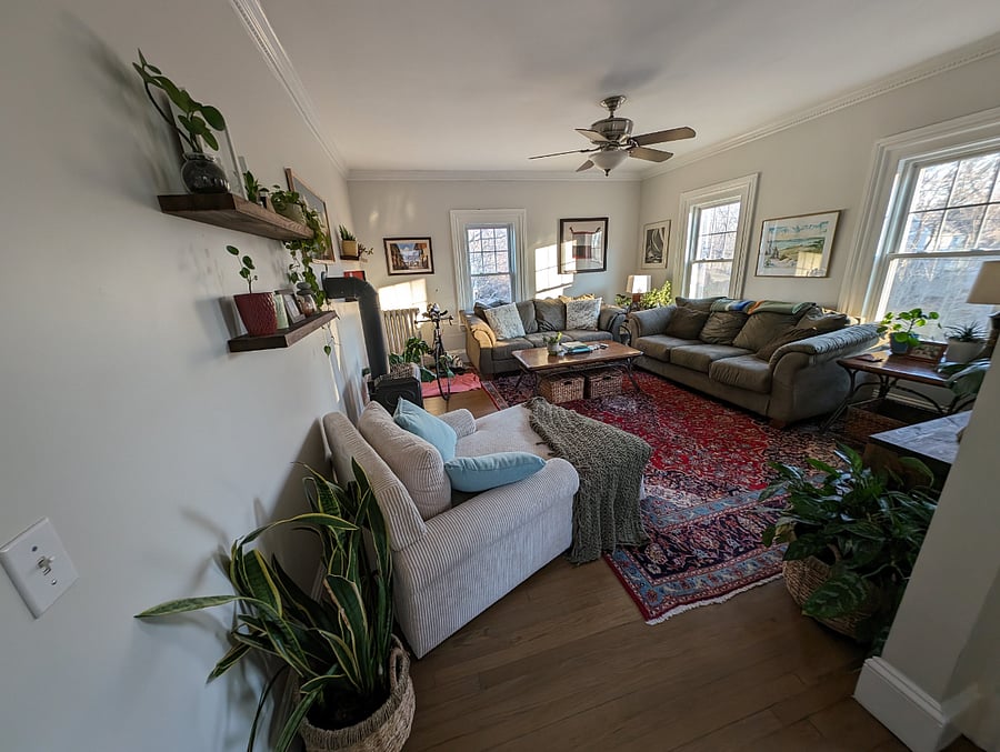 The living room is at the far other end of the condo near the front entrance, other bathroom, and our bedroom