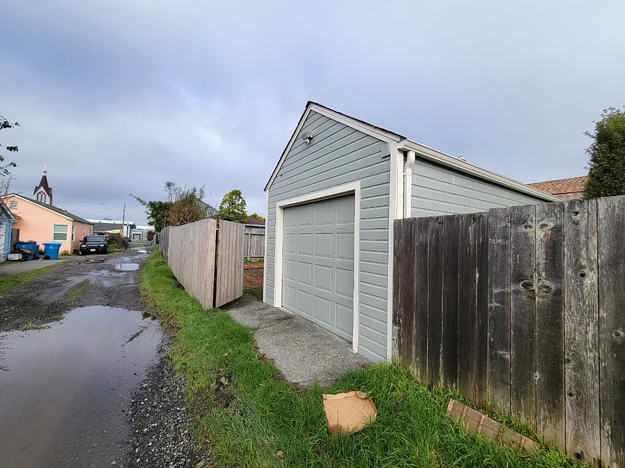 View of garage entrance from alley behind the property. 1 car garage with shelving for plenty of storage.