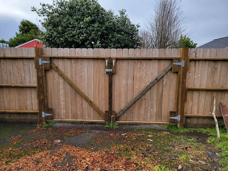 Double-wide gate that leads into the backyard for additional parking.