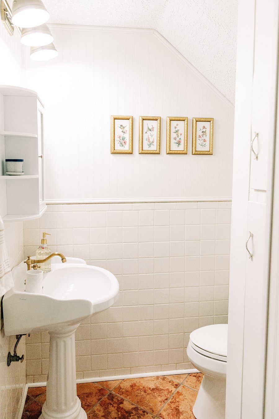Extra storage cabinet in bathroom between the shower and toilet.