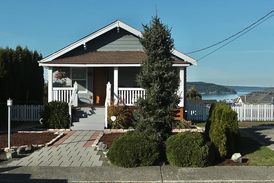 Street view showing water view in background and off-street parking on far right.