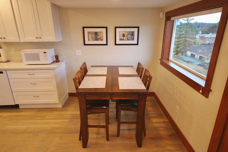 Tall kitchen table with four high chairs.