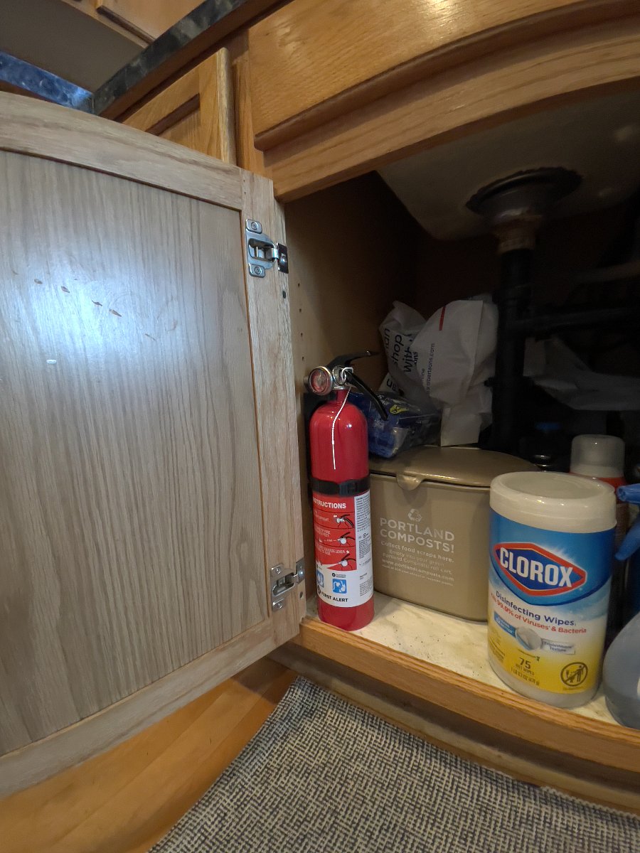 Fire extinguisher under the kitchen sink and under the sink in the shared upstairs bathroom