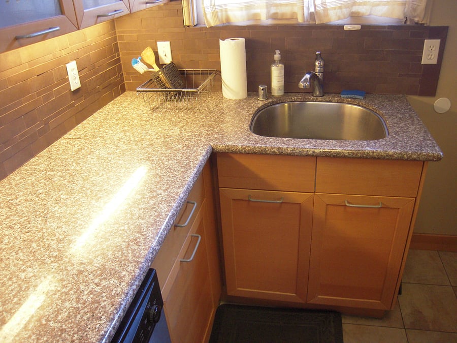 Granite counter tops with stainless steel sink with garbage disposal.