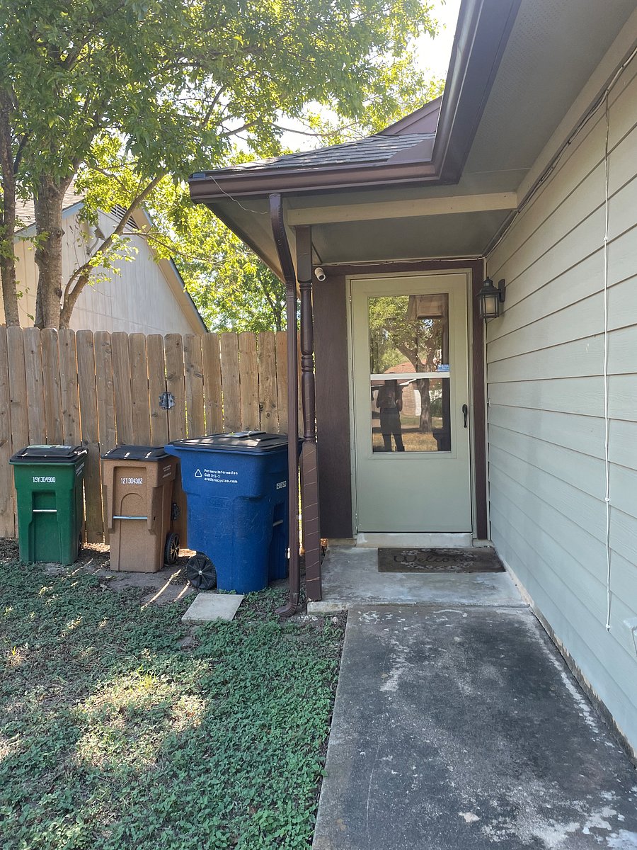 View of front door. My prior tenant like to keep the bins here, but I like them behind the fence or next to garage.